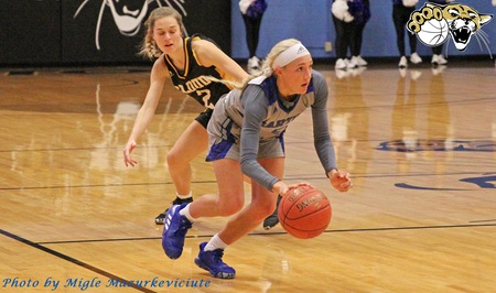 Barton women's basketball player Paige Talbott dribbles up the court.